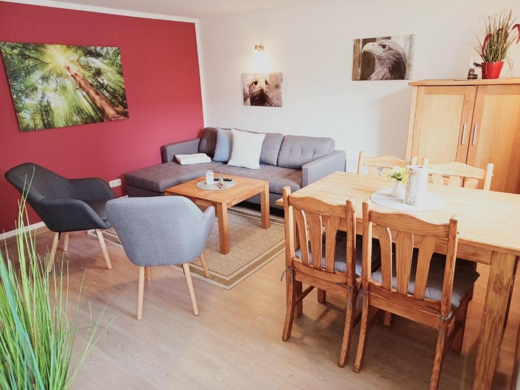 a living room with a table and a couch at FeWo Seeadler - Heuser Prerow in Prerow