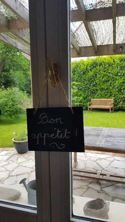 a sign on a door that reads born unpredictable at Chez Laurence &amp; RV in Vauréal
