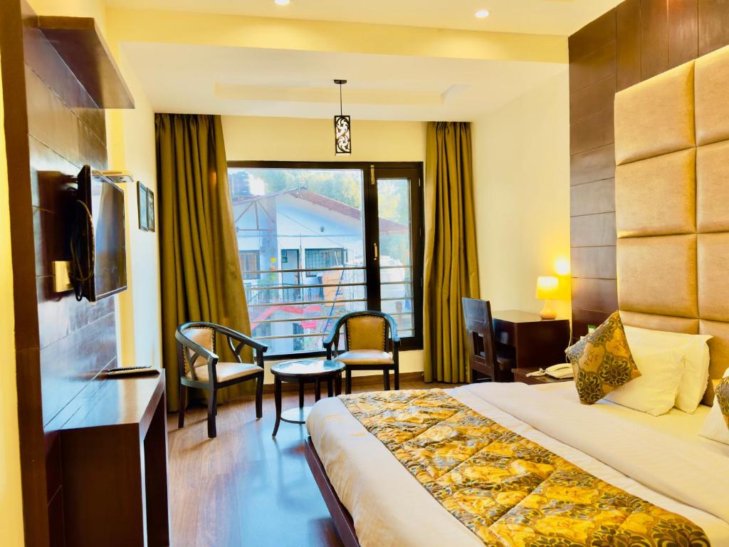 a hotel room with a bed and a balcony at Sarlod Guest house in Vapi