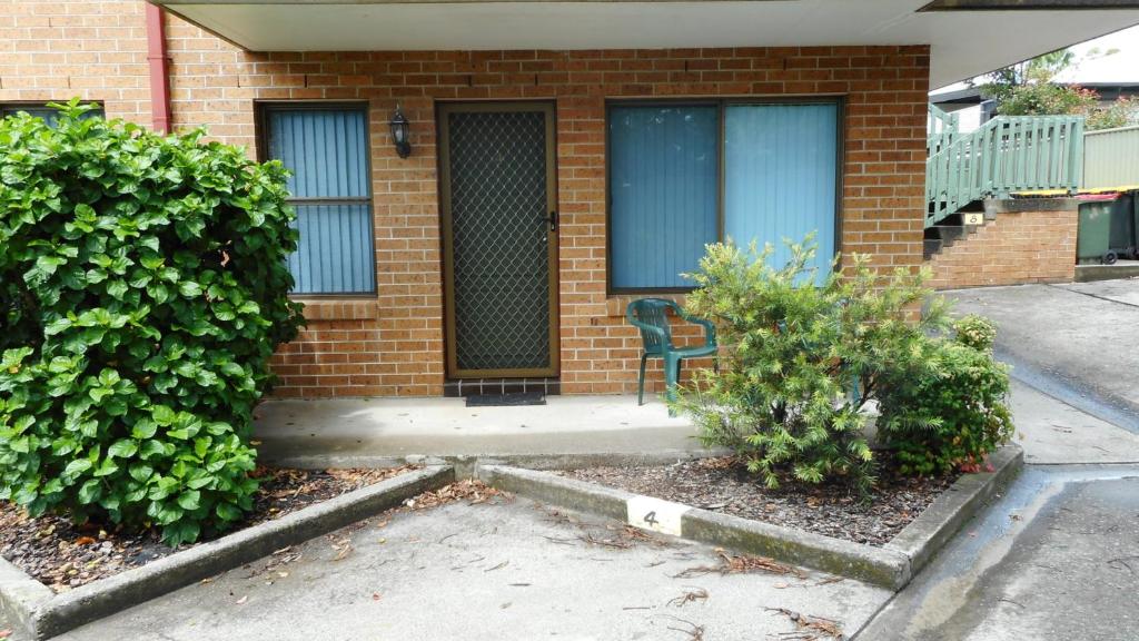 a brick house with a bench in front of it at Dunbar Court Unit 4 of 5 Memorial Ave South West Rocks - No Sheets or Towels Provided in South West Rocks