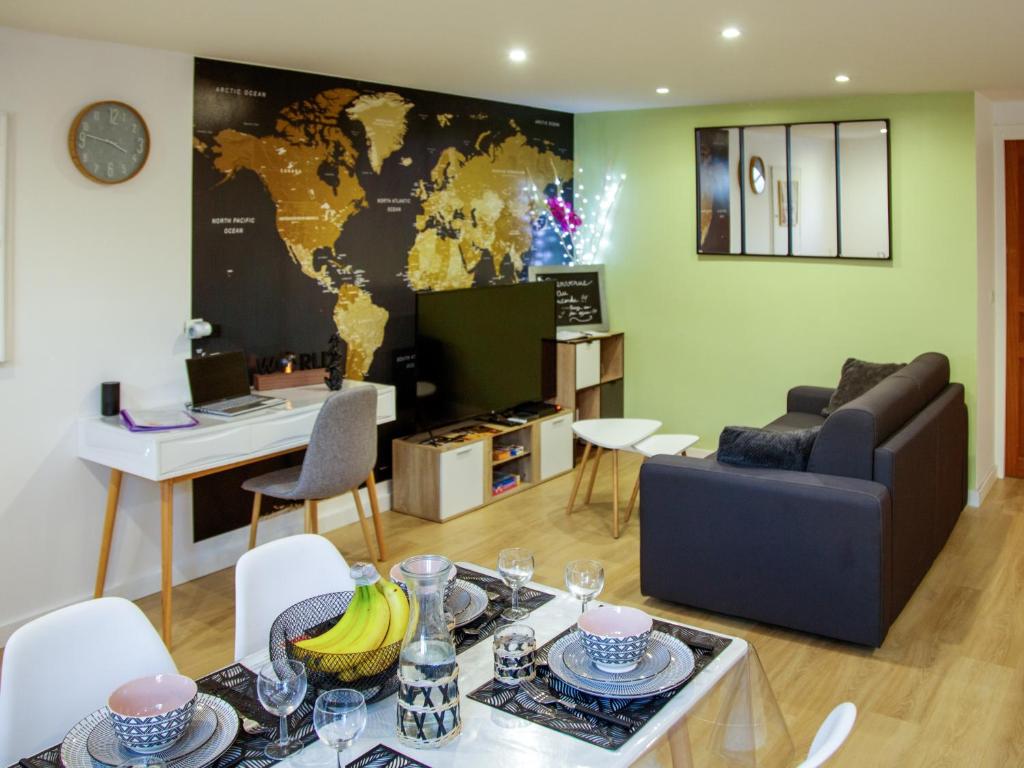 a living room with a map of the world on the wall at LE CONCORDE-WIFI-Clim-Parking-3étoiles-OcKeys in Bram