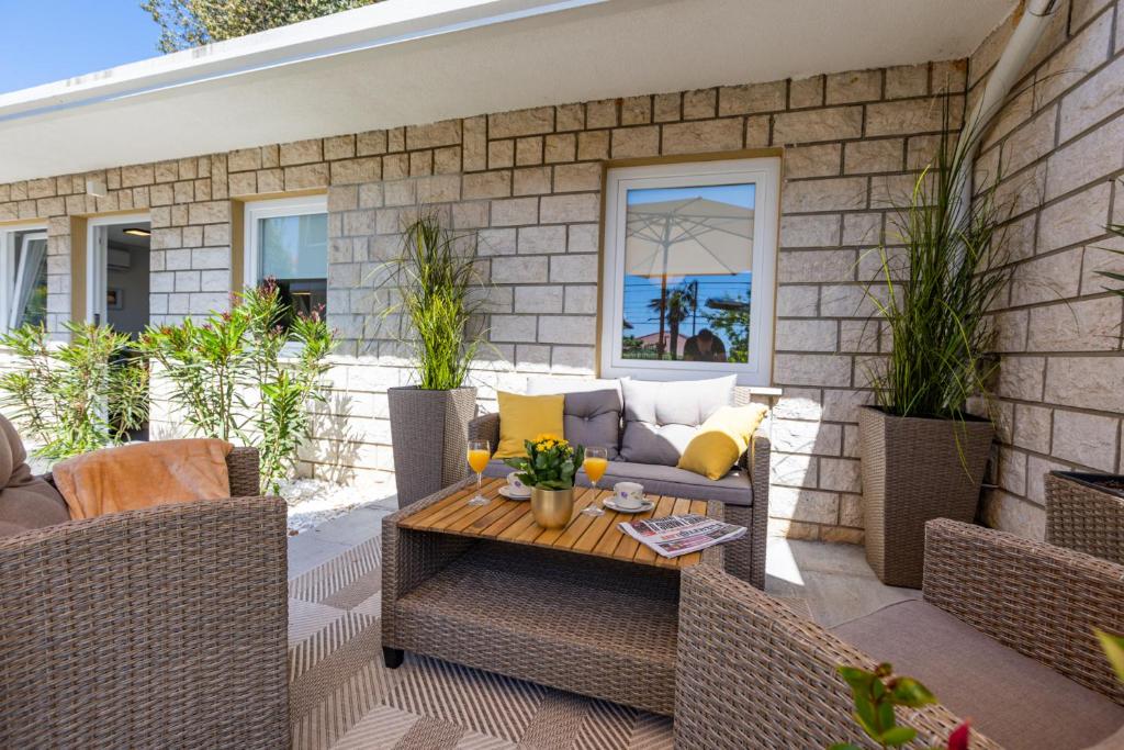 a patio with a couch and a table at Villa Marica Tiny House in Krk city centre in Krk