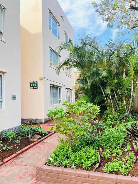 a building with a garden in front of a building at Frere Hill Guesthouse in Durban