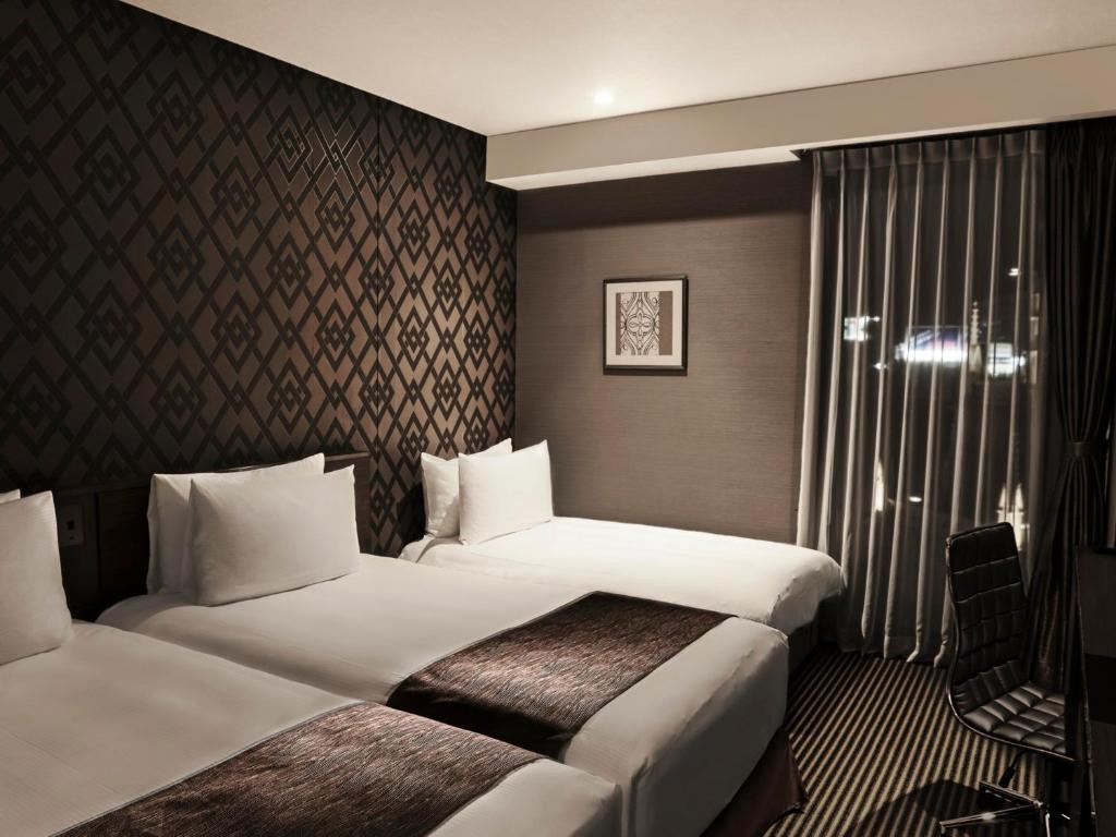 Postel nebo postele na pokoji v ubytování The Strings Hotel Nagoya