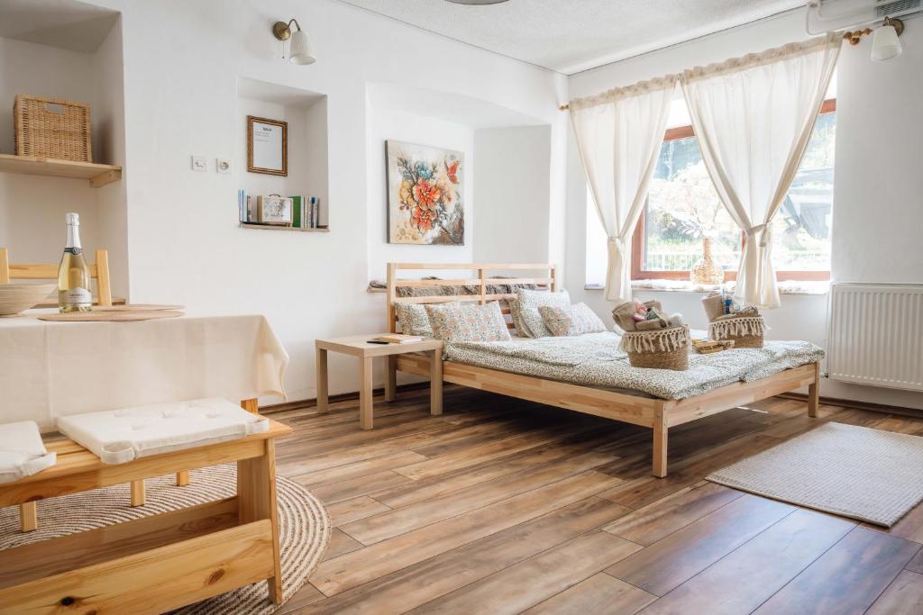 a living room with a bed and a large window at Apartma Roner in Podbrdo