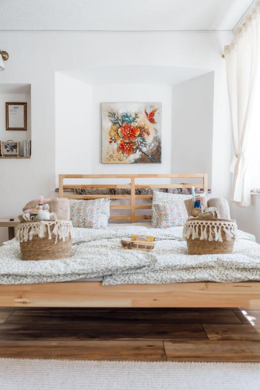 a bed with two baskets on it in a room at Apartma Roner in Podbrdo