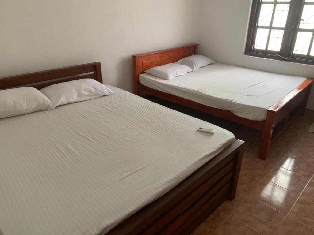 two beds in a room with at Rajarata Villa Anuradhapura in Anuradhapura