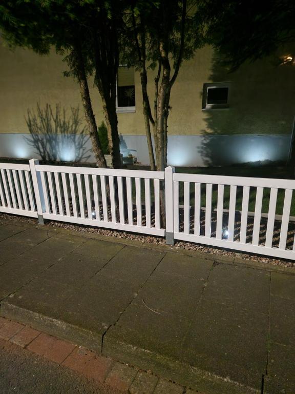 a white picket fence in front of a house at Detmolder Perle in Detmold