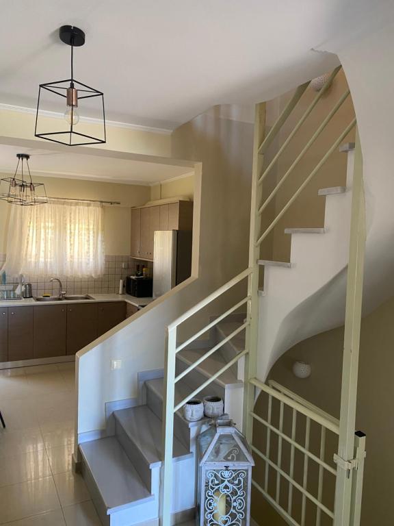 una cocina y una escalera en una casa en Aiolos Seaside Villa, en Kanali