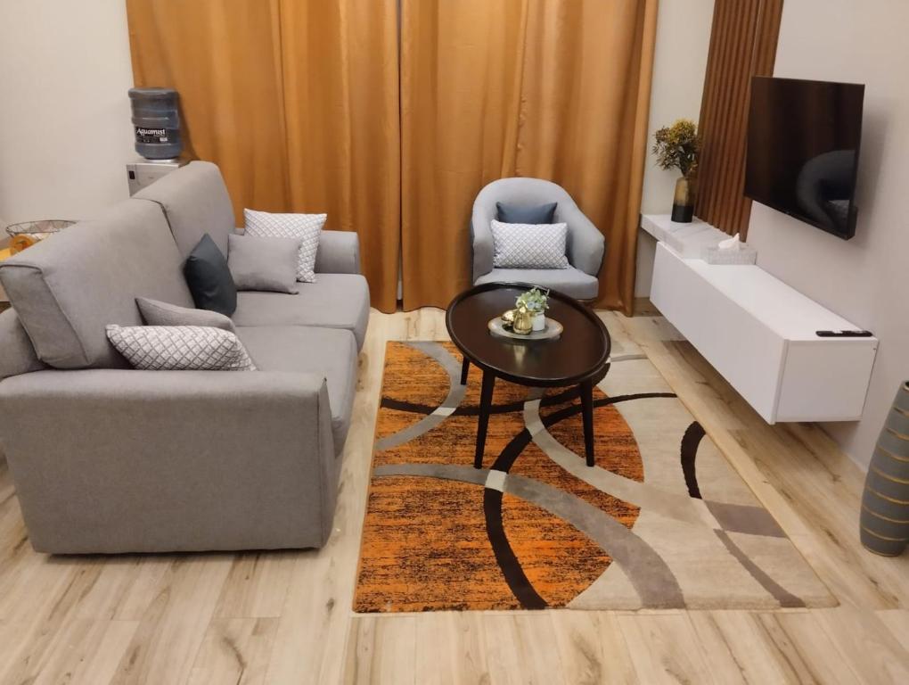 a living room with a couch and a table at Elegant and comfy apartment in Westlands, Nairobi in Nairobi