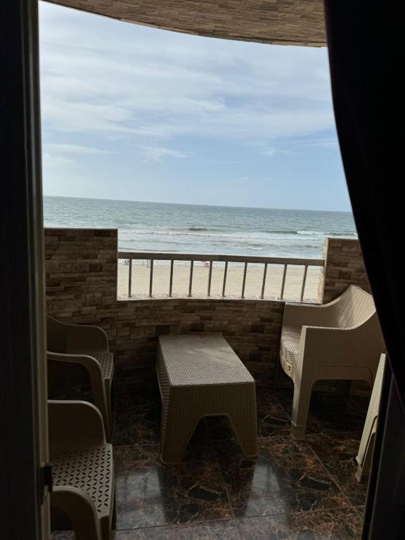 a room with a view of the ocean from a balcony at Family Condo With Panoramic Sea View 1 in Alexandria