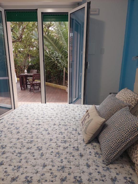 a bedroom with a bed and sliding glass doors at Albamare in Monterosso al Mare