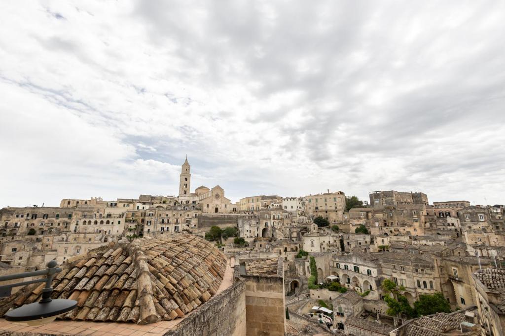 Blick auf eine Stadt vom Dach eines Gebäudes in der Unterkunft Antica Dimora Storica La Finestra Sul Campanile in Matera