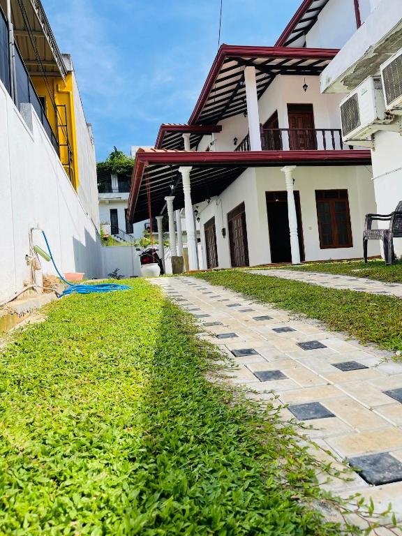 a cobblestone path in front of a house at Serendib Villa Mirissa in Mirissa