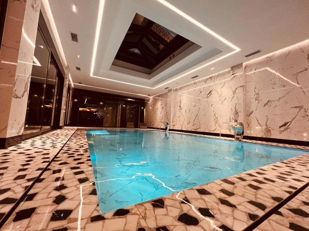 a swimming pool in the middle of a building at Vera HOTEL-VILLA in Pristina