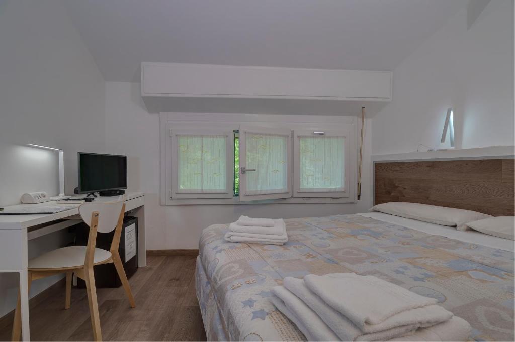 A bed or beds in a room at Il Colombé B&B