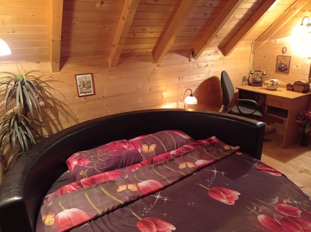 a bed with a blanket on top of it in a room at ČAROBNI KUTAK in Kruševac