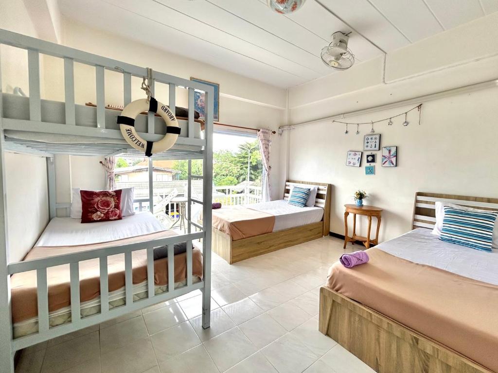 a bedroom with two bunk beds and a balcony at Family Room by one love group in Phra Nakhon Si Ayutthaya