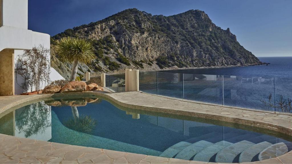 a swimming pool with a view of a mountain at Santa Eulalia - 4739 Ibiza in Cala Llonga