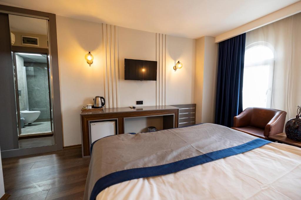 Postel nebo postele na pokoji v ubytování Aktas Hotel