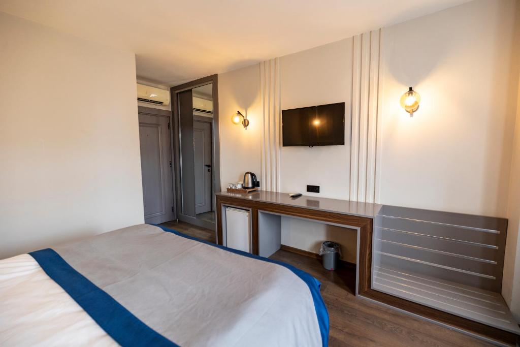 Postel nebo postele na pokoji v ubytování Aktas Hotel