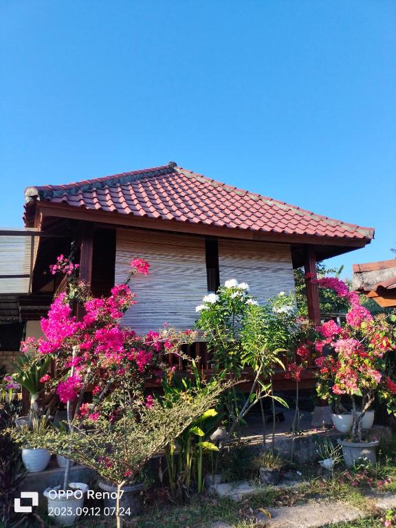 a house with flowers in front of it at Bogenvil villa in Tanjung