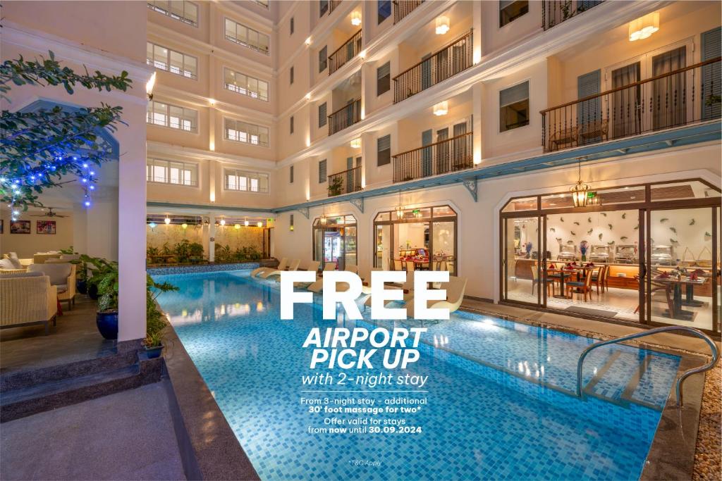 um anúncio para um edifício de apartamentos com piscina em Amina Lantana Hoi An Hotel & Spa em Hoi An