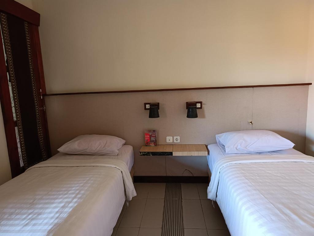 Postel nebo postele na pokoji v ubytování Keola Hotel Legian