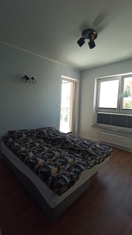 Posteľ alebo postele v izbe v ubytovaní APARTAMENT PRZYSTAŃ