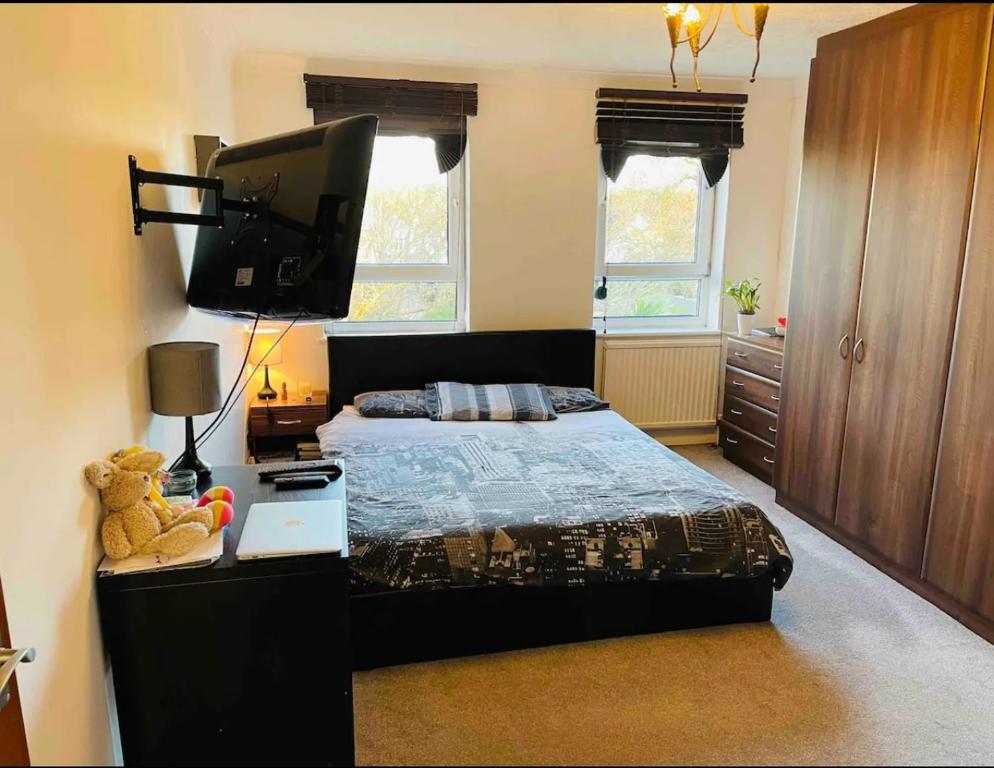 a bedroom with a bed and a flat screen tv at Beautiful One Bedroom Flat in London in Woodford Green