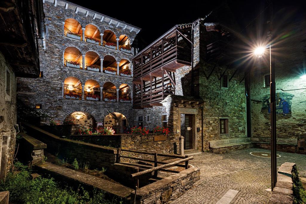 VilladossolaにあるDimora Storica Casa Vanniの窓と通り灯りのある石造りの建物