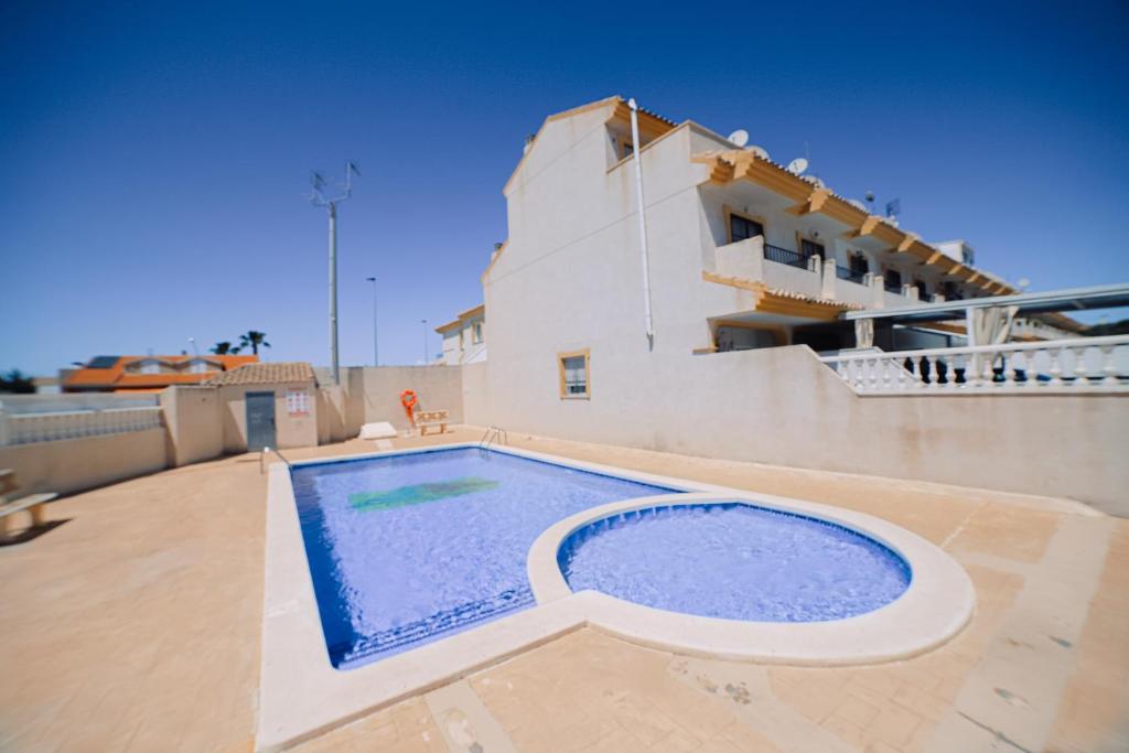 a swimming pool on the roof of a house at Casita Mar Menor in Santiago de la Ribera