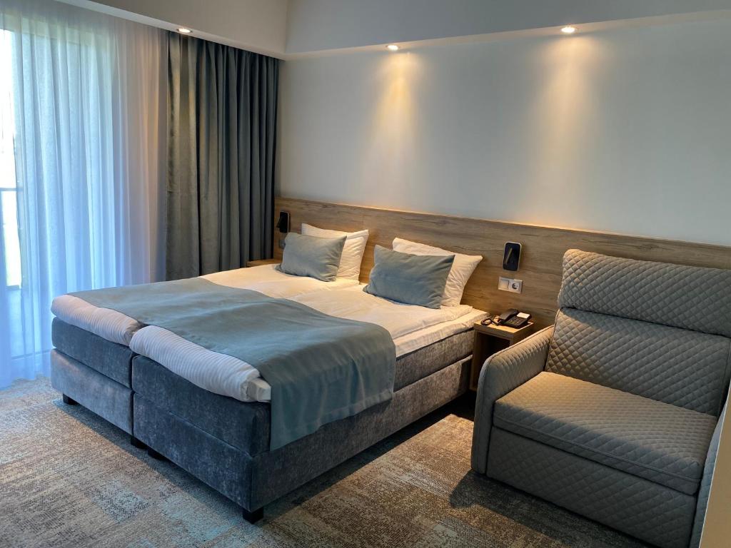 Postel nebo postele na pokoji v ubytování Molėtai Hotel