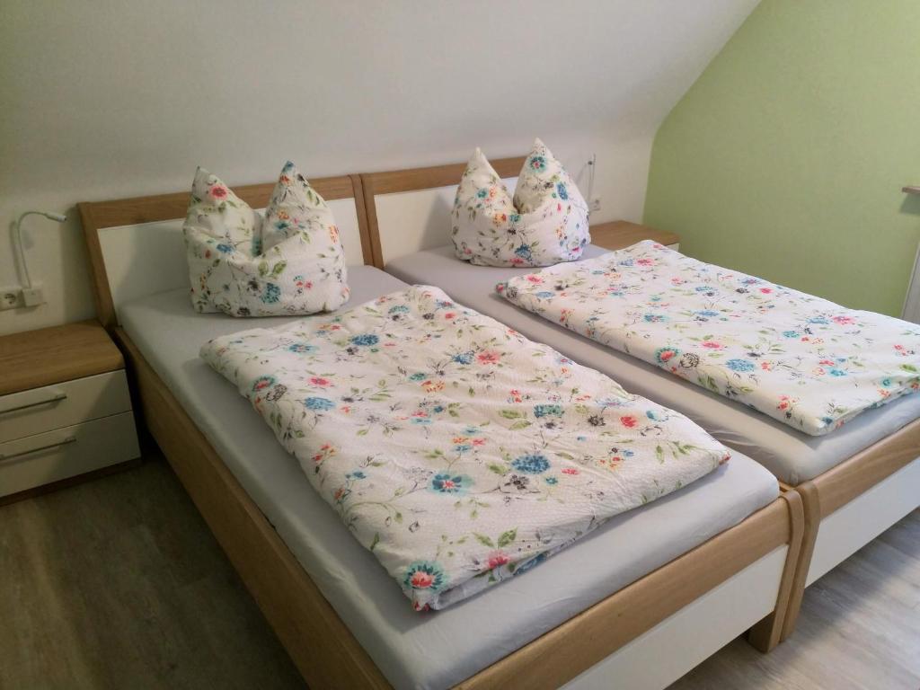 two twin beds with pillows on them in a room at Ferienwohnung Morretalblick in Buchen