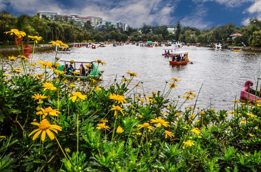 a group of people in boats on a lake at Campo Filipino Dormitelle powered by Cocotel in Baguio