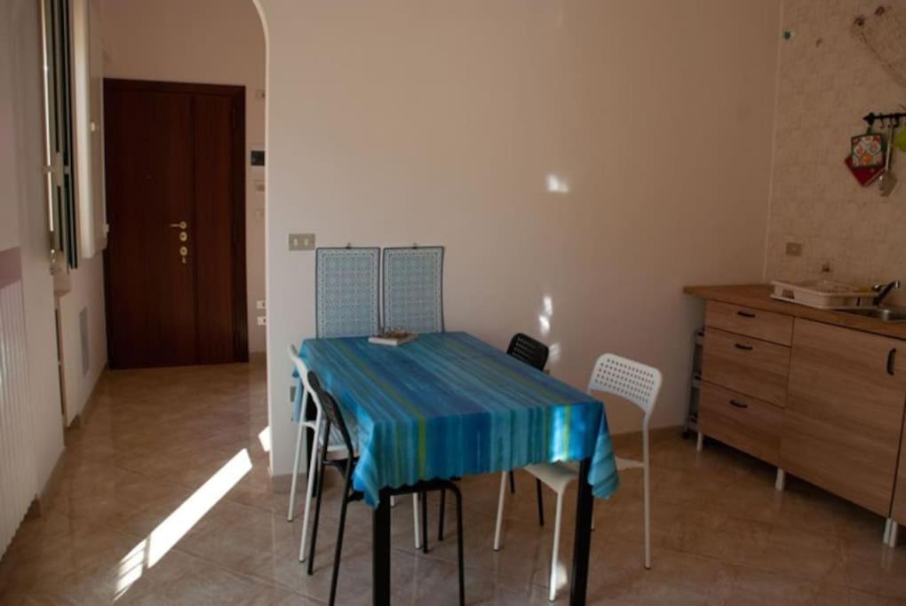 a table and chairs in a kitchen with a blue table cloth at Una casa accogliente per il tuo soggiorno in Barletta