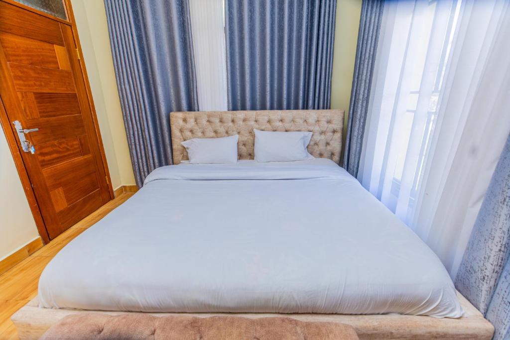 Krevet ili kreveti u jedinici u okviru objekta Kigali Wings Apartment 2 B