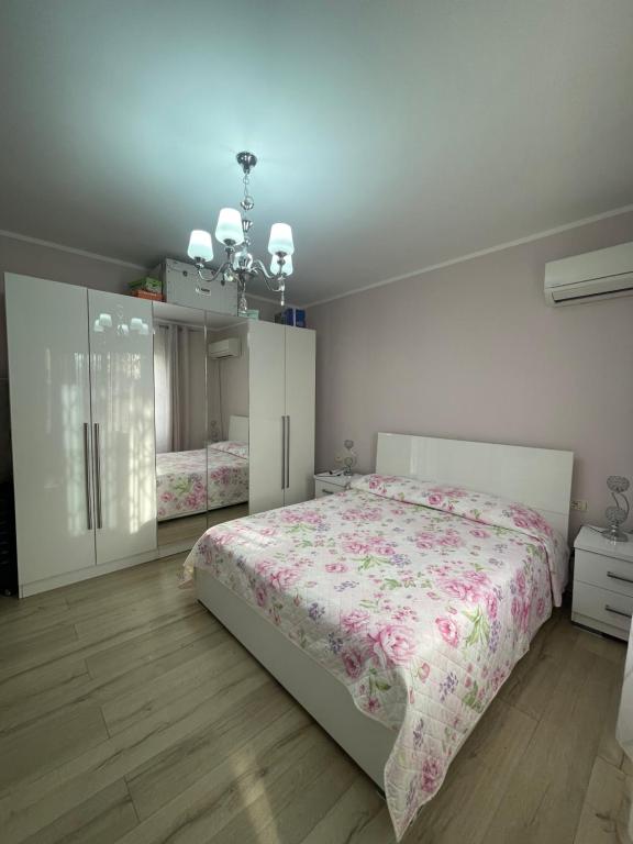 ein Schlafzimmer mit einem großen Bett und einem Kronleuchter in der Unterkunft Private House Shkoder in Shkodra