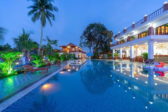 a large swimming pool in front of a building at Serene Resort Phú Quốc in Phu Quoc