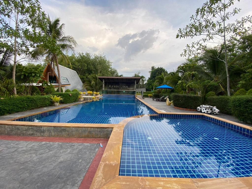 a swimming pool with blue tiles in a resort at Krabi Inn Resort in Ao Nam Mao