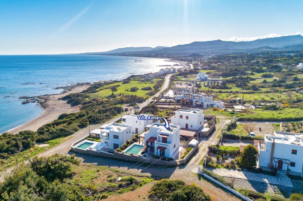 an aerial view of a beach with white houses at Villa Kiotari by Villa Plus in Kiotari