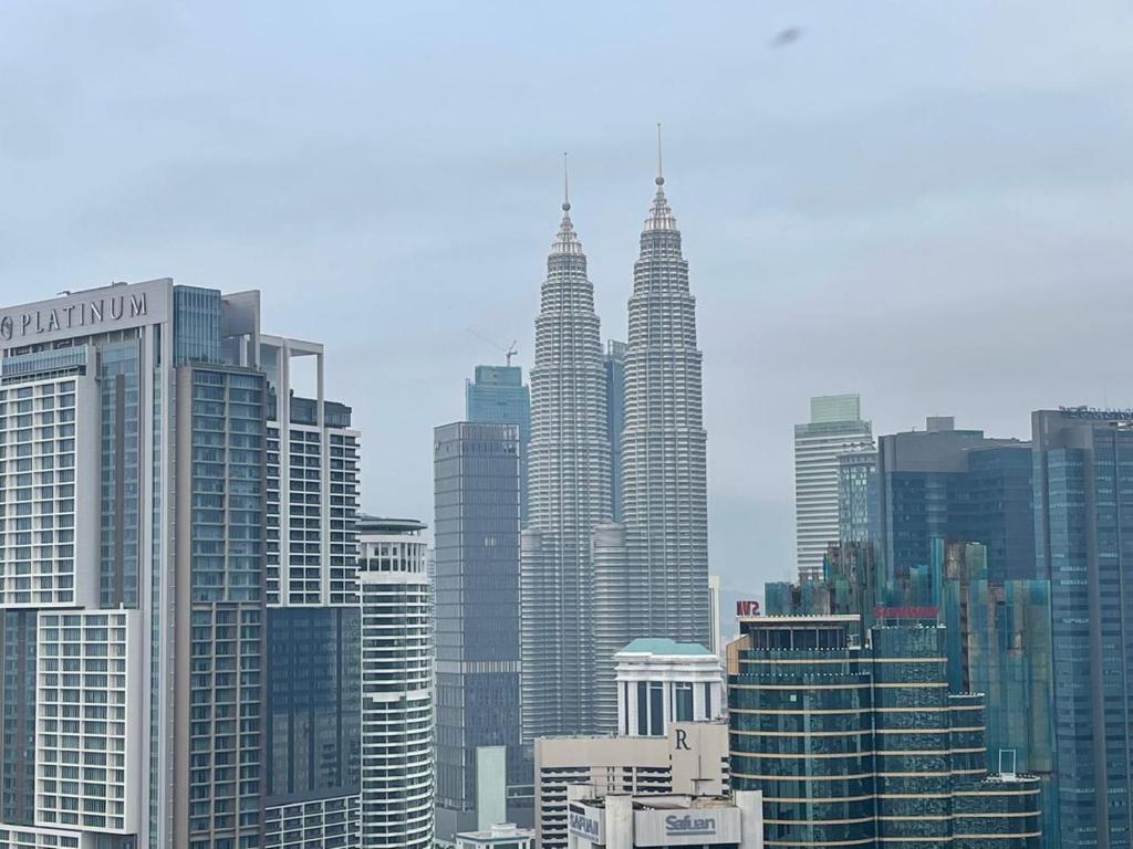 a view of a large city with tall buildings at Anggun Suite KL in Kuala Lumpur