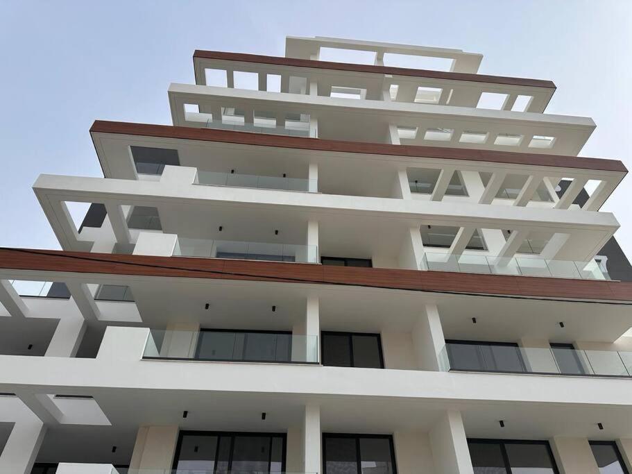 an apartment building with balconies on top of it at Cozy 3 Bedroom Apartment 300M from the SEA in Larnaka