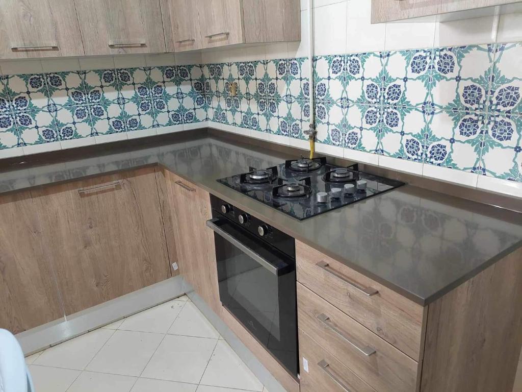 a kitchen with a stove and a counter top at 3 Bedrooms appartment in Nabeul