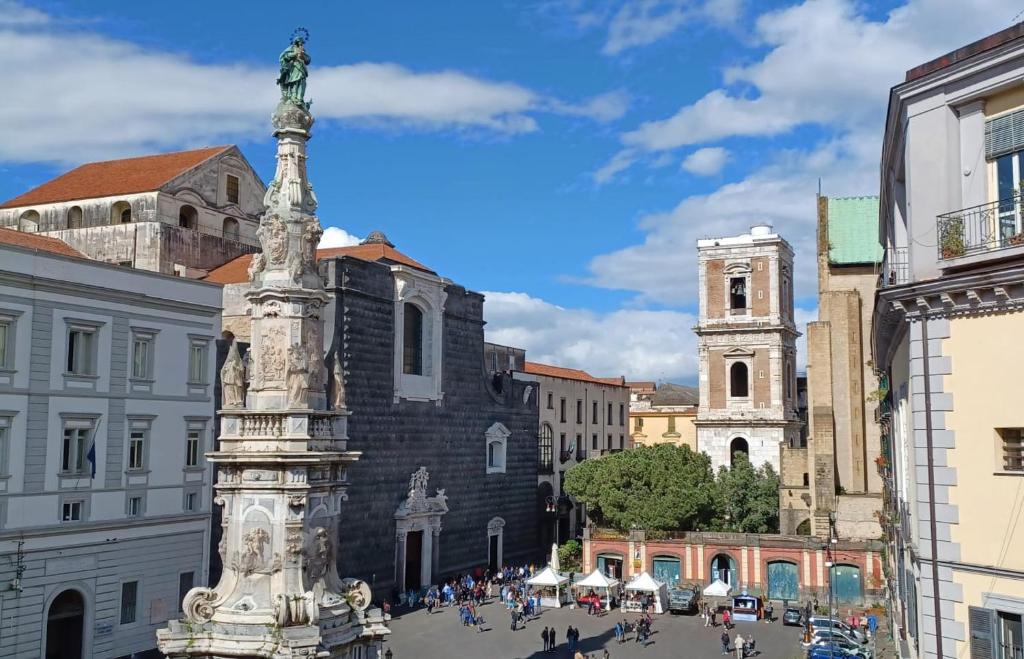 a statue in the middle of a city street at Maison Degas-Dimora di Charme in Naples