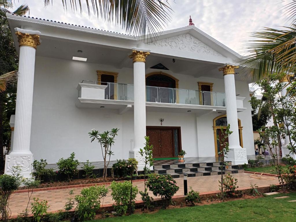 a white house with columns at SULANG Villa ECR chennai in Chennai