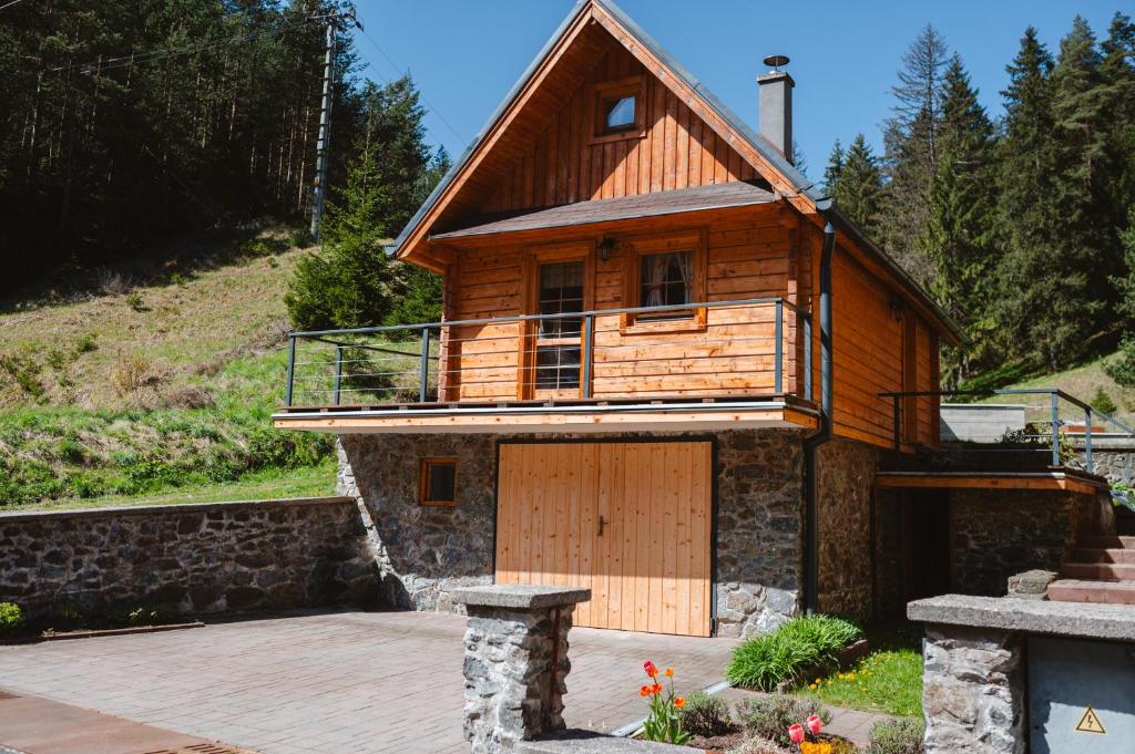 a wooden house with a large wooden garage at Chata JÚLIA in Vernár