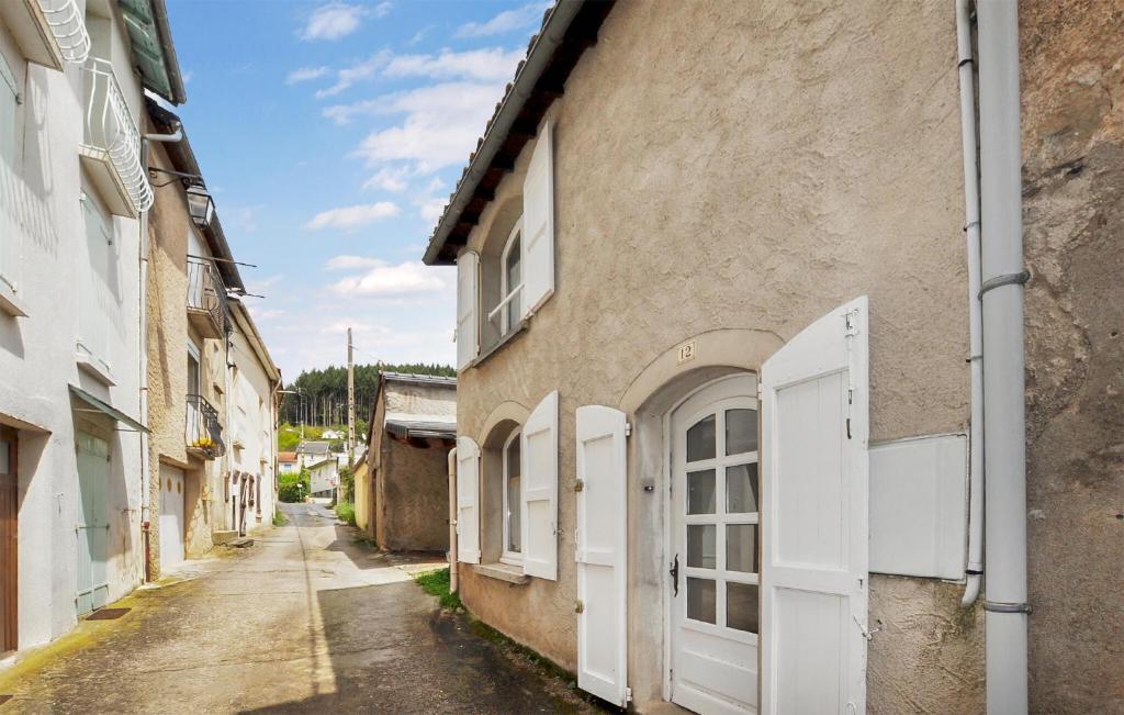 um beco com portas brancas num edifício em Gorgeous Home In Saint-jean-du-bruel With Kitchen em Saint-Jean-du-Bruel