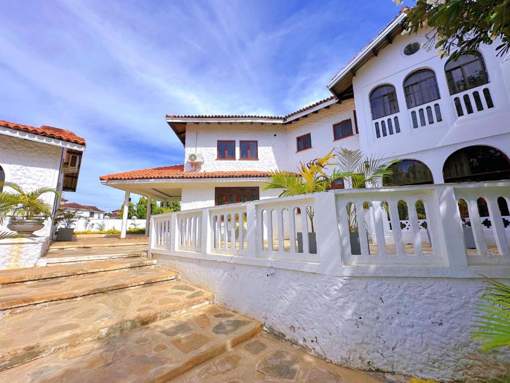 a white fence in front of a house at Villa Ella in Mombasa
