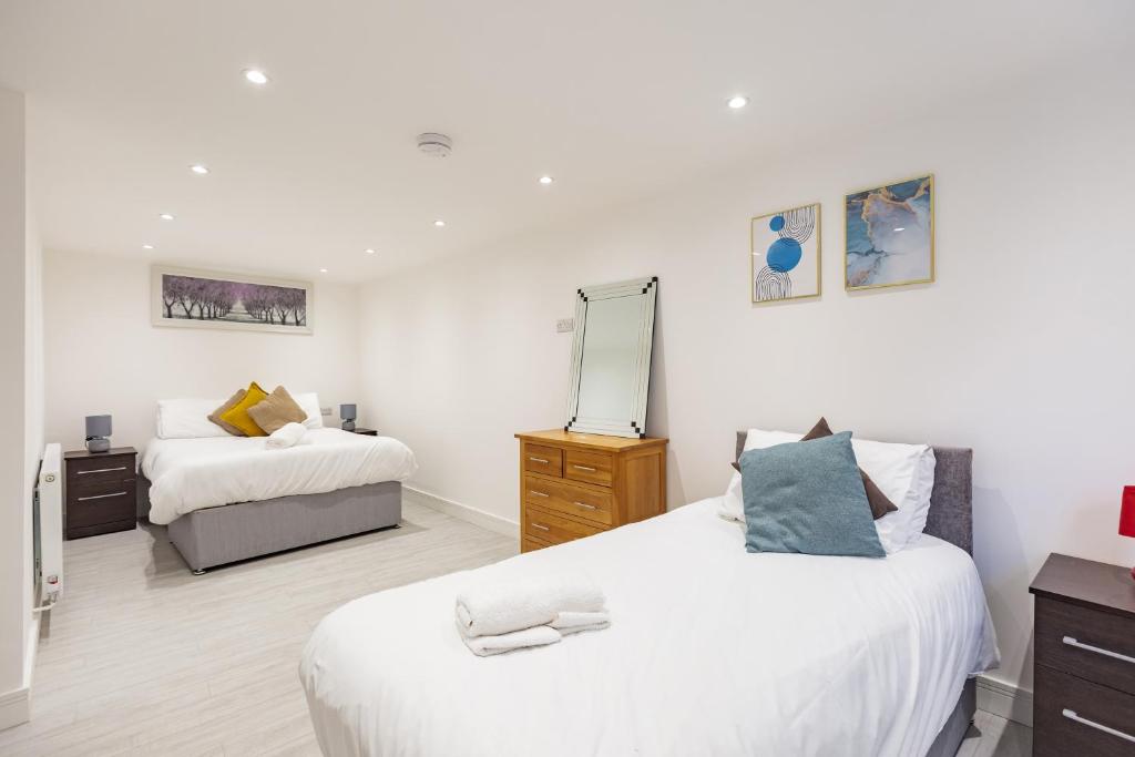 a bedroom with two beds and a mirror at Pembroke Heights in Chatham
